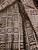 Brown fabric with white geometric patterns on a dark surface