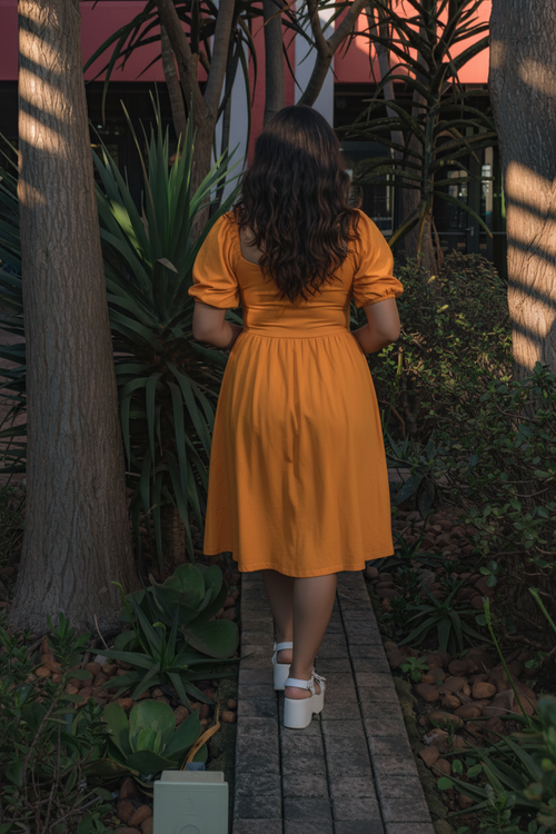 Back view of yellow puff sleeve midi dress