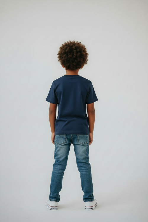 Boy in navy t-shirt back view studio