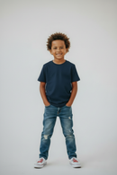 Boy in navy t-shirt front view studio