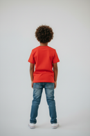 Boy in red t-shirt back view studio