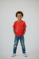 Boy in red t-shirt studio background